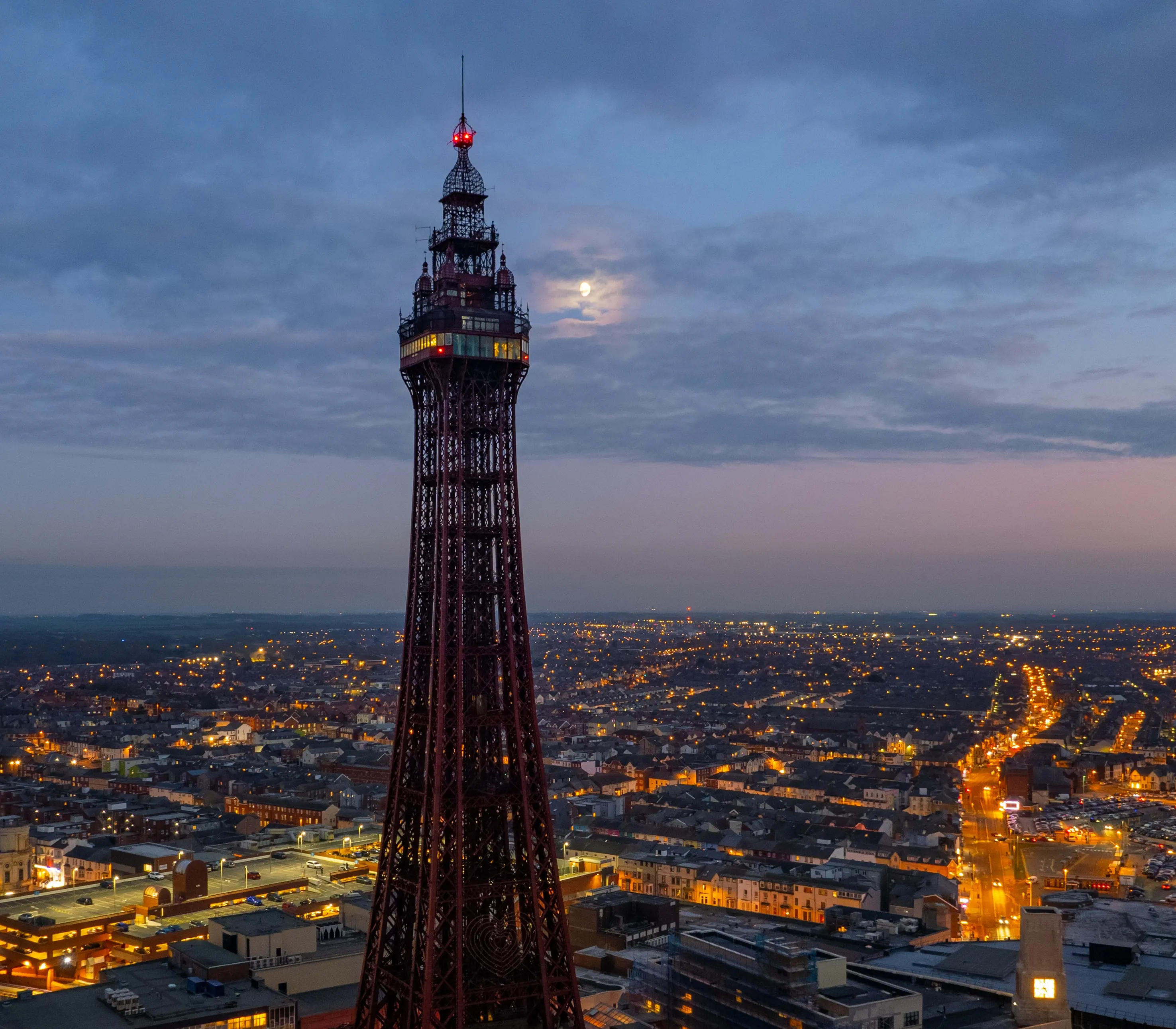 A close-up shot of the Blackpool Tower seen from the sky at dusk